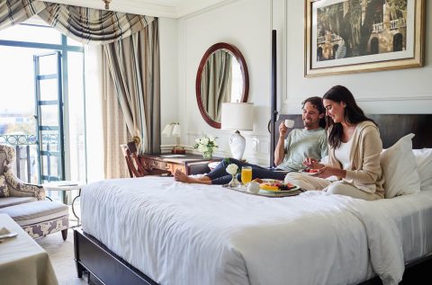 A couple enjoying breakfast in their suite at The Charleston Place