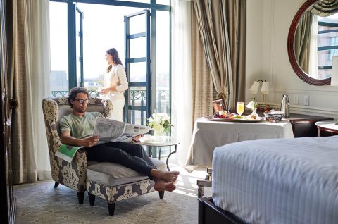 A couple enjoying brunch in their suite at The Charleston Place