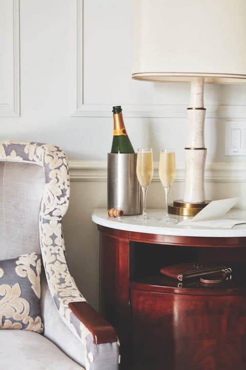 A bottle and two glasses of champagne from The Charleston Place
