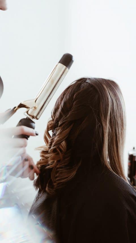 A bride getting her hair done on her wedding day
